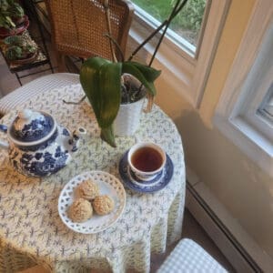 Tea, scones, and teapot on table.