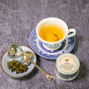 Cup of Dreamberry tea and tea strainer.